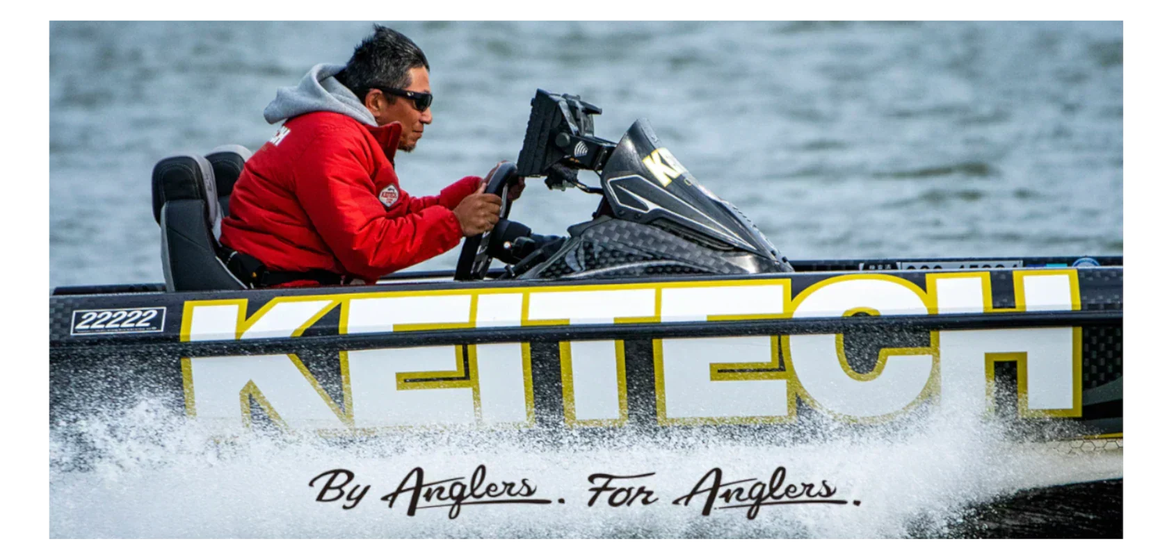 Professional angler driving a boat with KEITECH branding – By Anglers, For Anglers