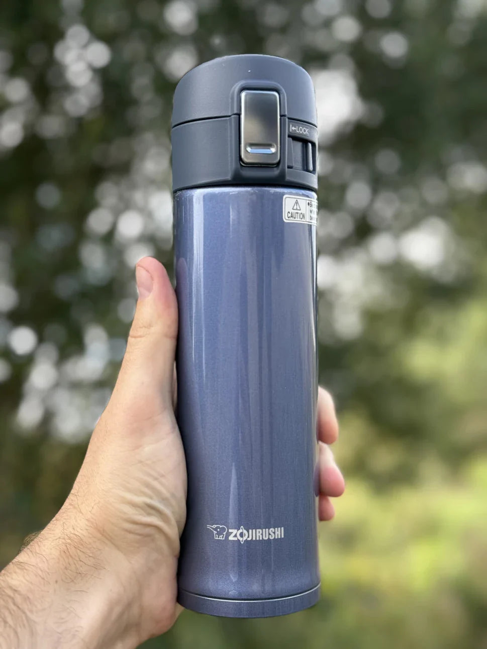 Portable Zojirushi stainless steel mug in blue, shown outdoors in Ireland for travel and everyday hydration