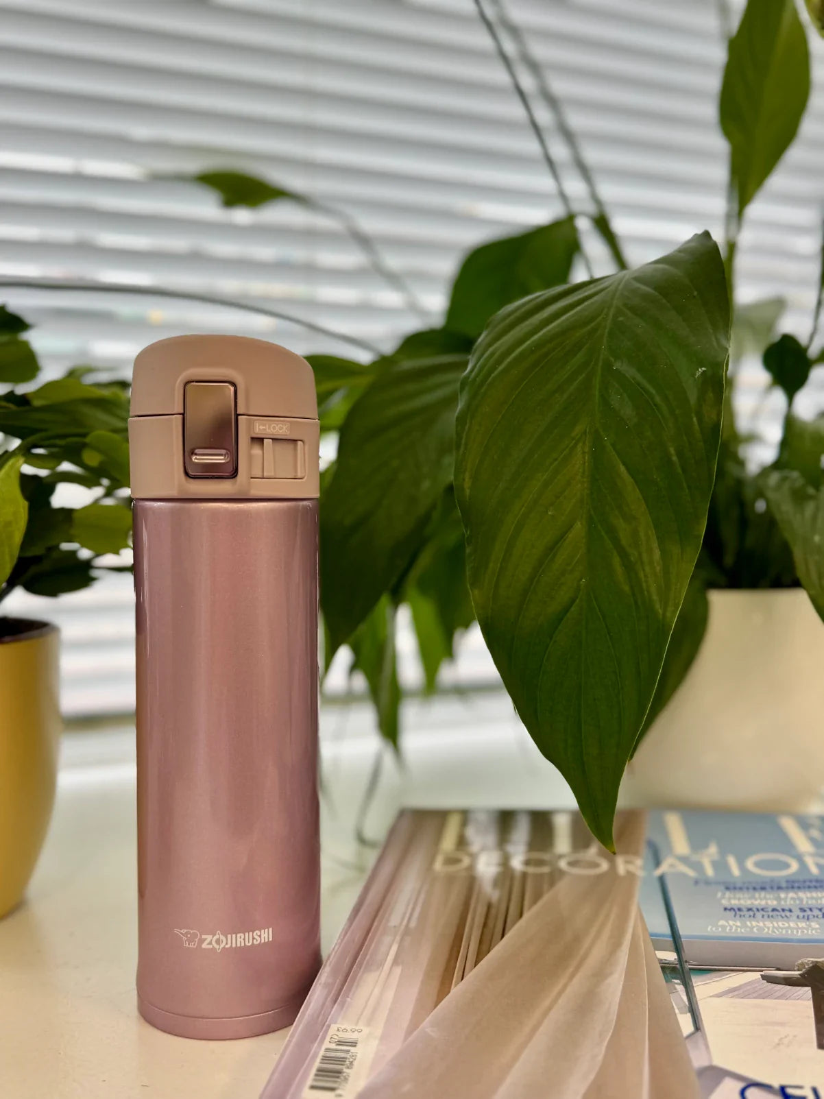 Zojirushi SM-KHE pink travel mug open lid showing leak proof design, lifestyle photo