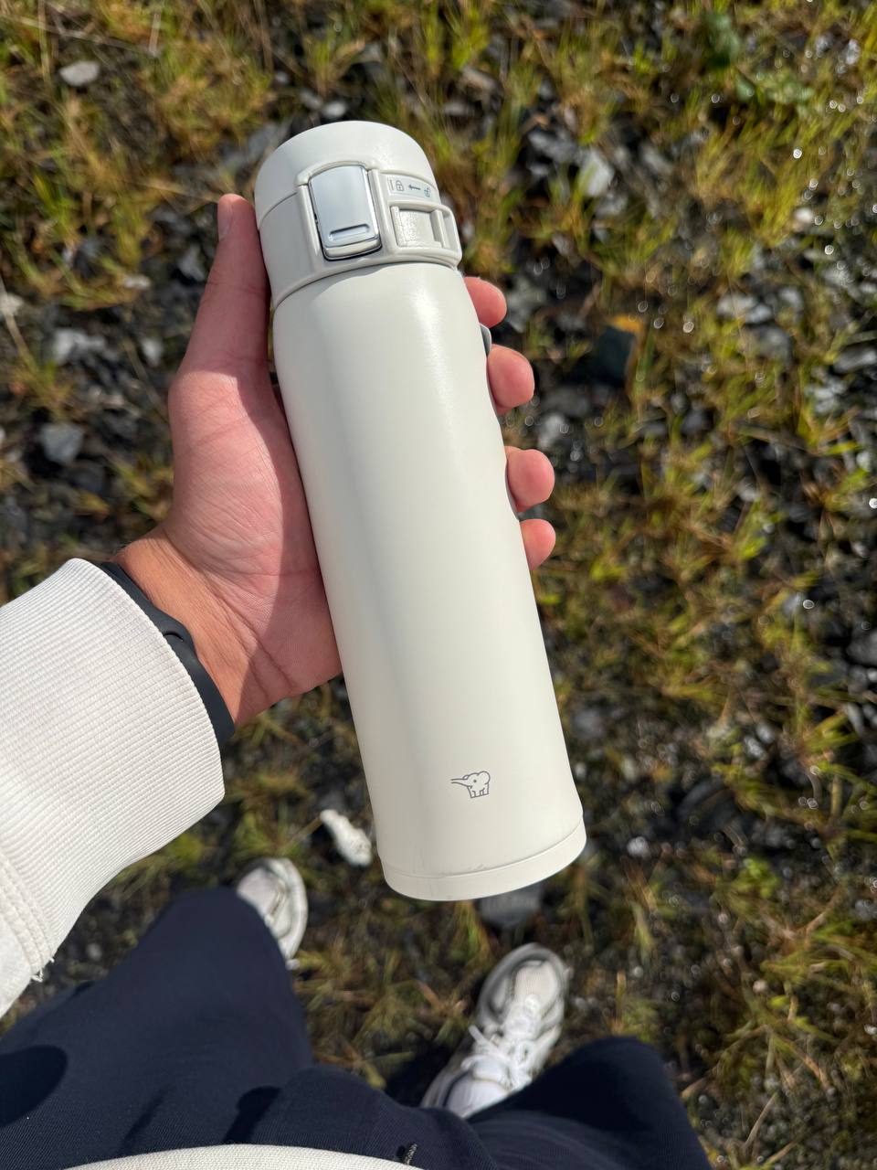 Portable Zojirushi SH-SF white travel mug in use outdoors, ideal for daily hydration in Ireland
