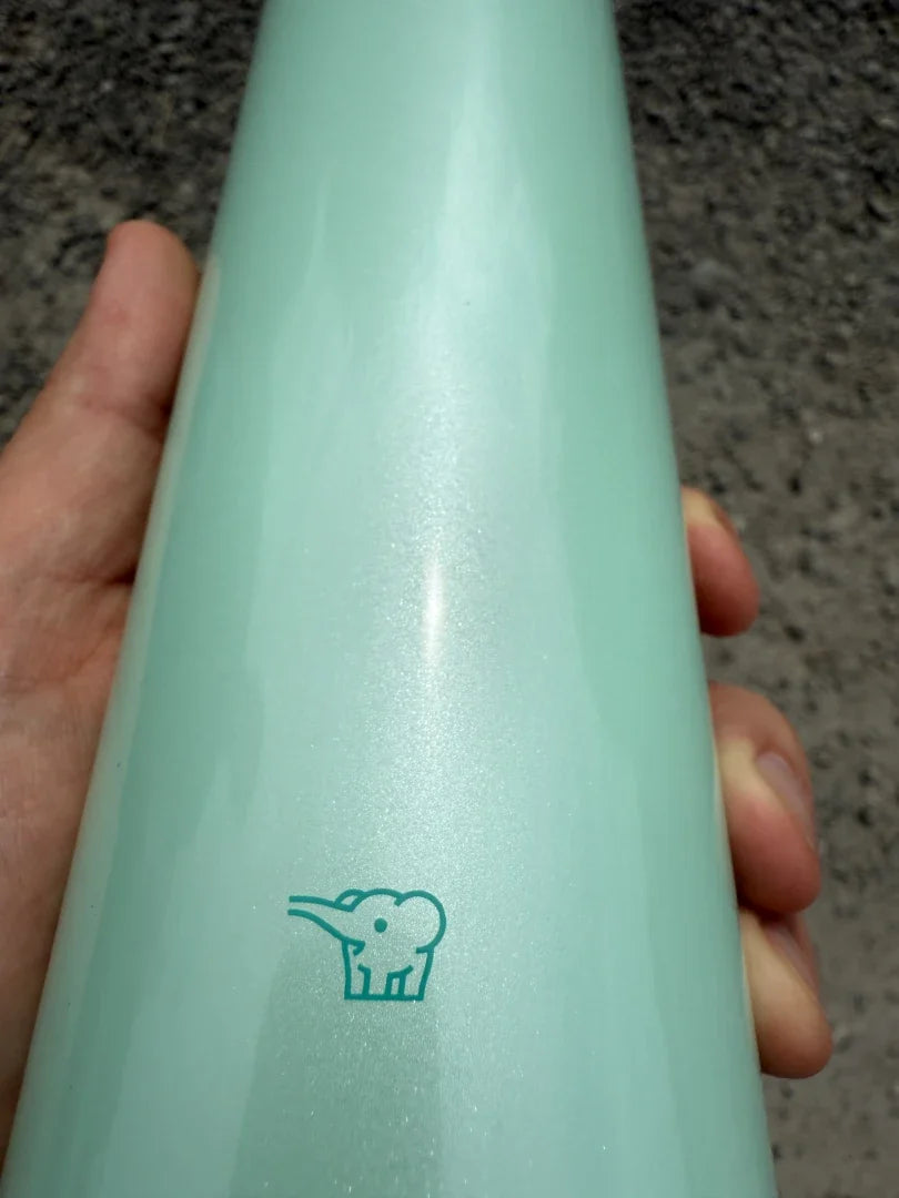Close-up of Zojirushi logo on SM-SR60 Mint stainless steel insulated travel mug, BPA-free design.