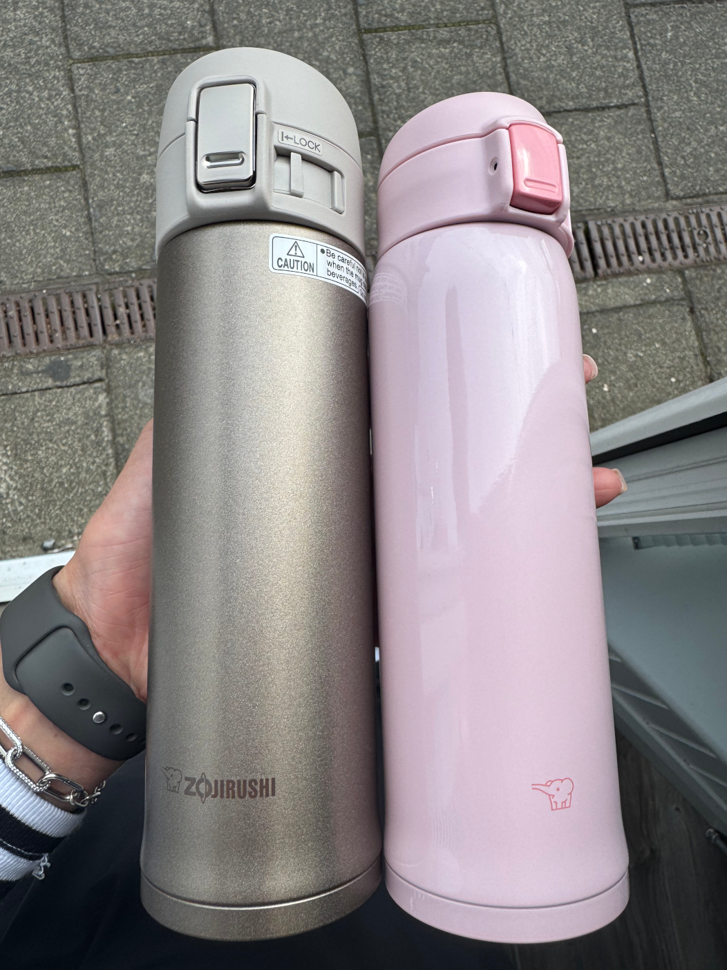 Zojirushi SM-SR pink insulated travel mug being held in hand ergonomic slim design
