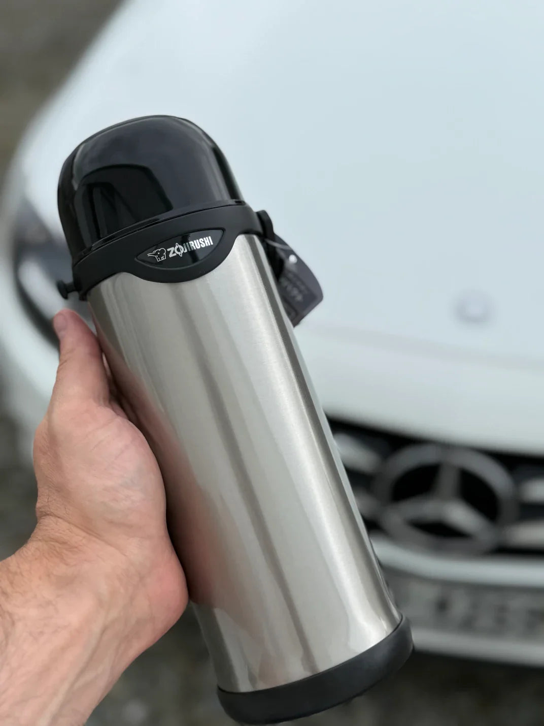 Zojirushi SJ-S stainless steel thermos in hand, lightweight and easy to carry